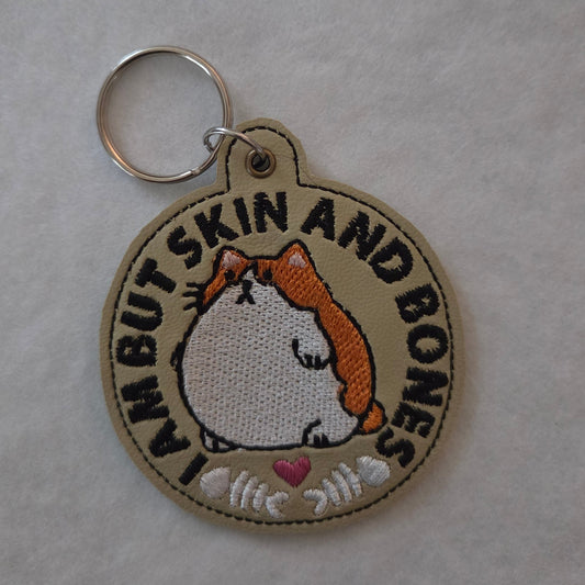 I Am But Skin And Bones Embroidered Vinyl Key Ring